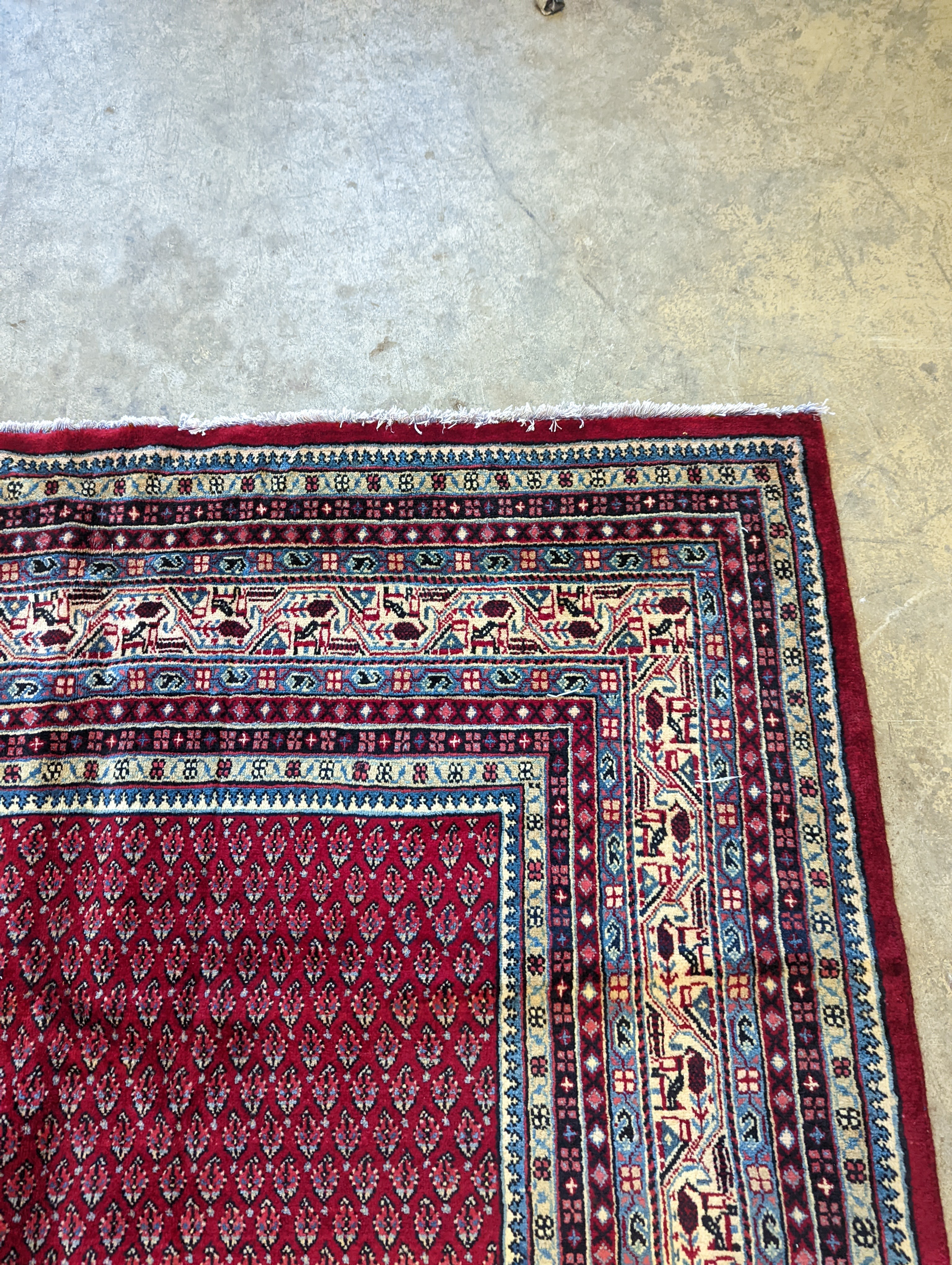 An Araak crimson ground carpet, 350 x 250cm